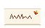 A folded place card with a name in script and an autumn leaf in the corner.